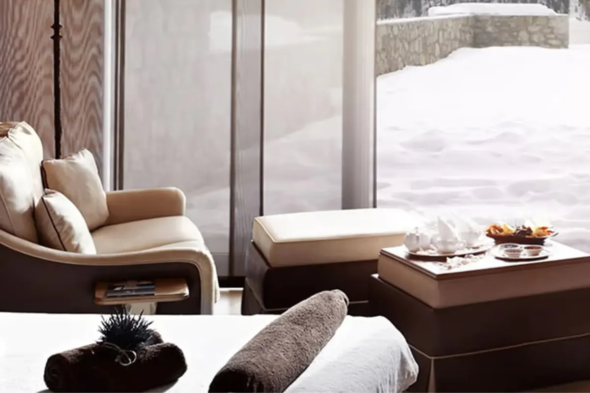Spa lounge with upholstered seating, view of snow-covered mountains
