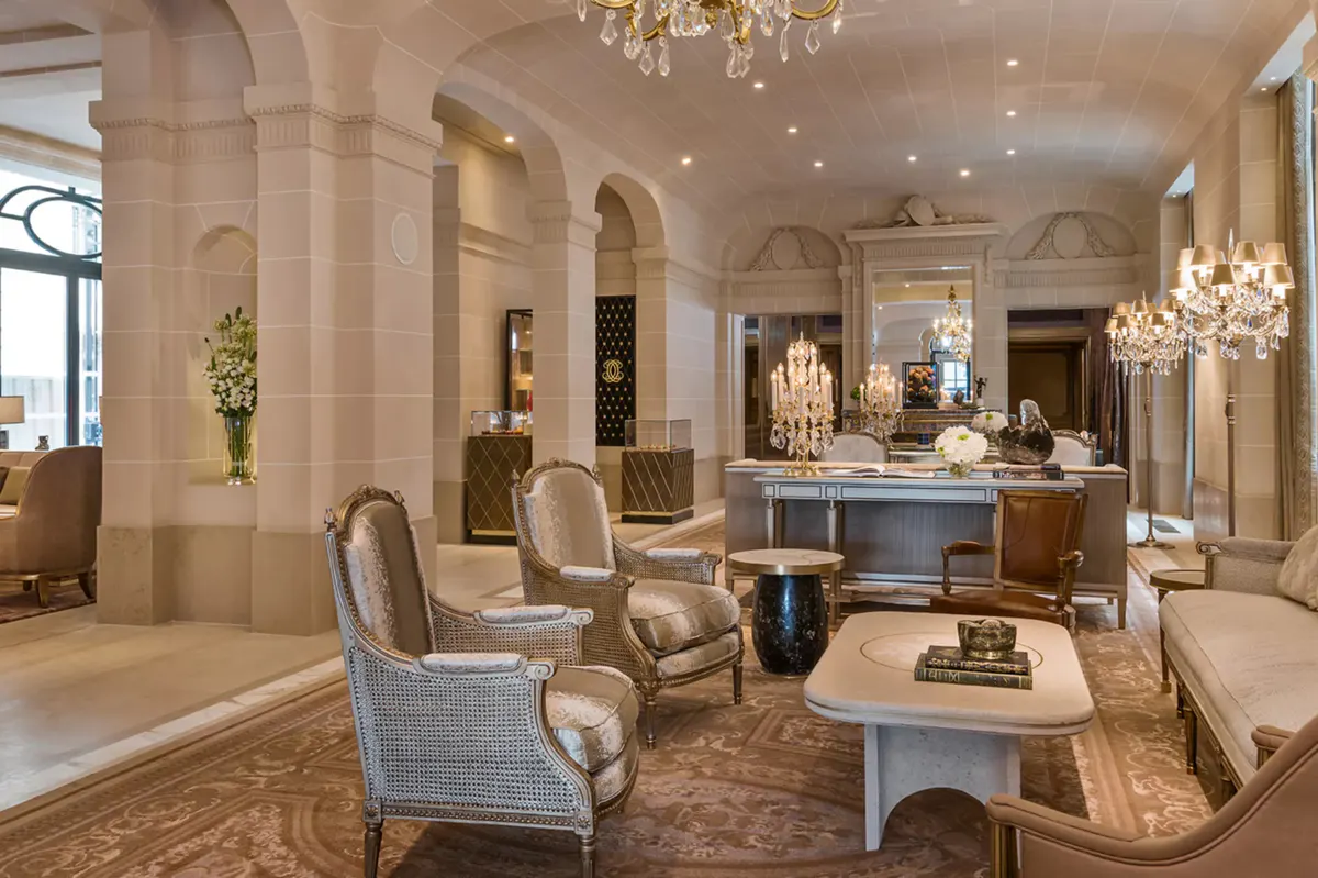 Grand lobby with chandelier, pale columns, and spacious classical architecture