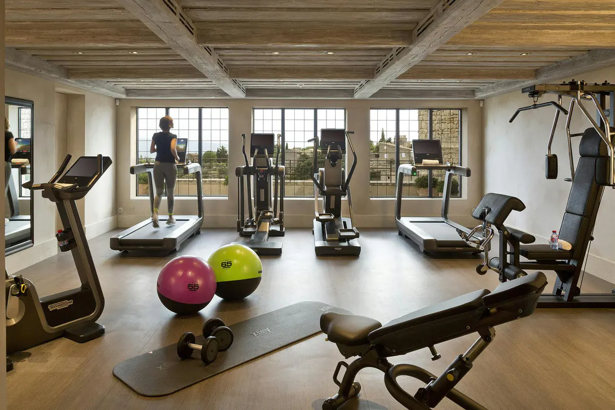 Fitness room with exercise equipment and valley views through windows