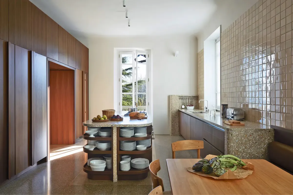 A kitchen workspace with tiled backsplash and marble cooking island