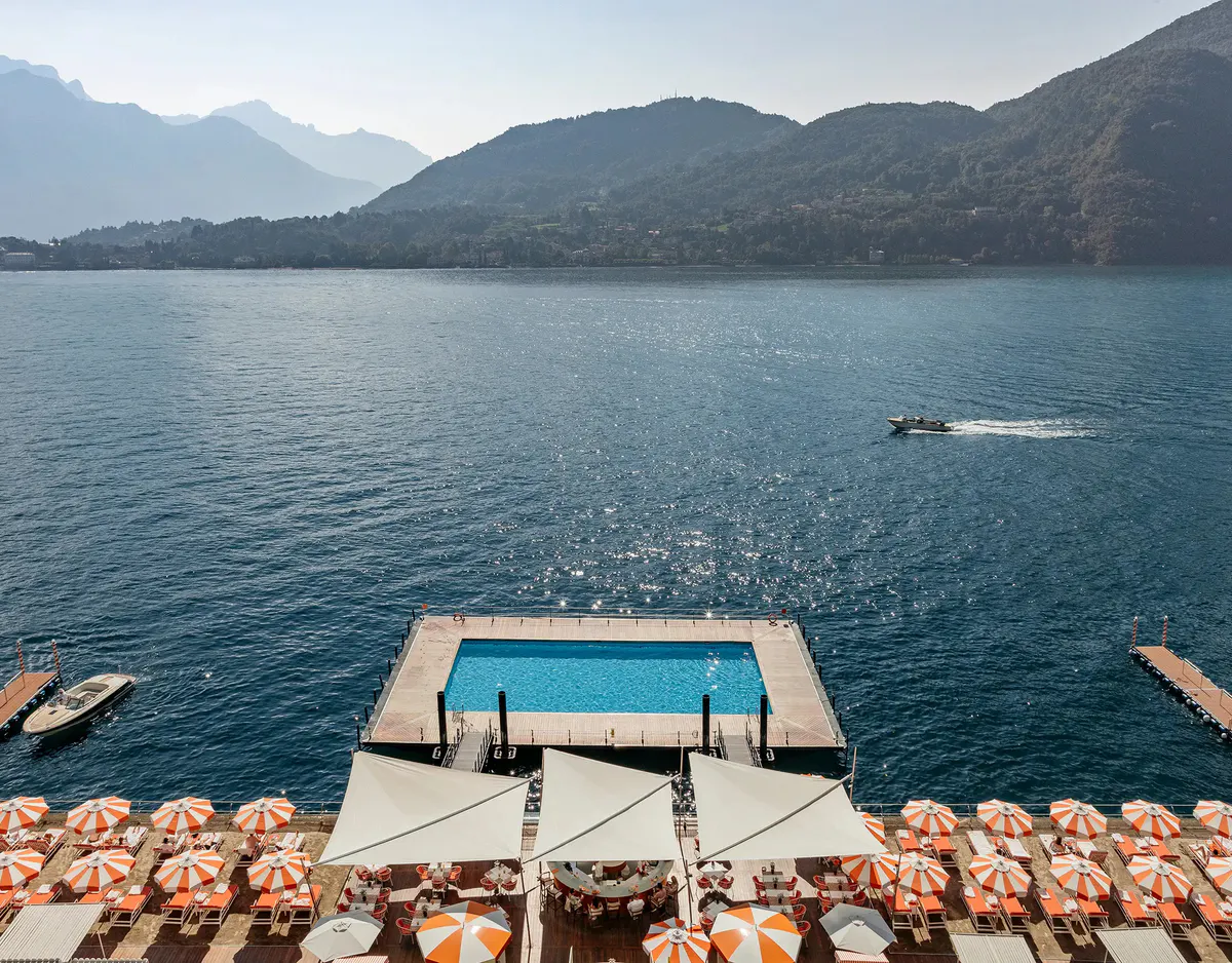 The renowned floating pool on Lake Como with mountain backdrop