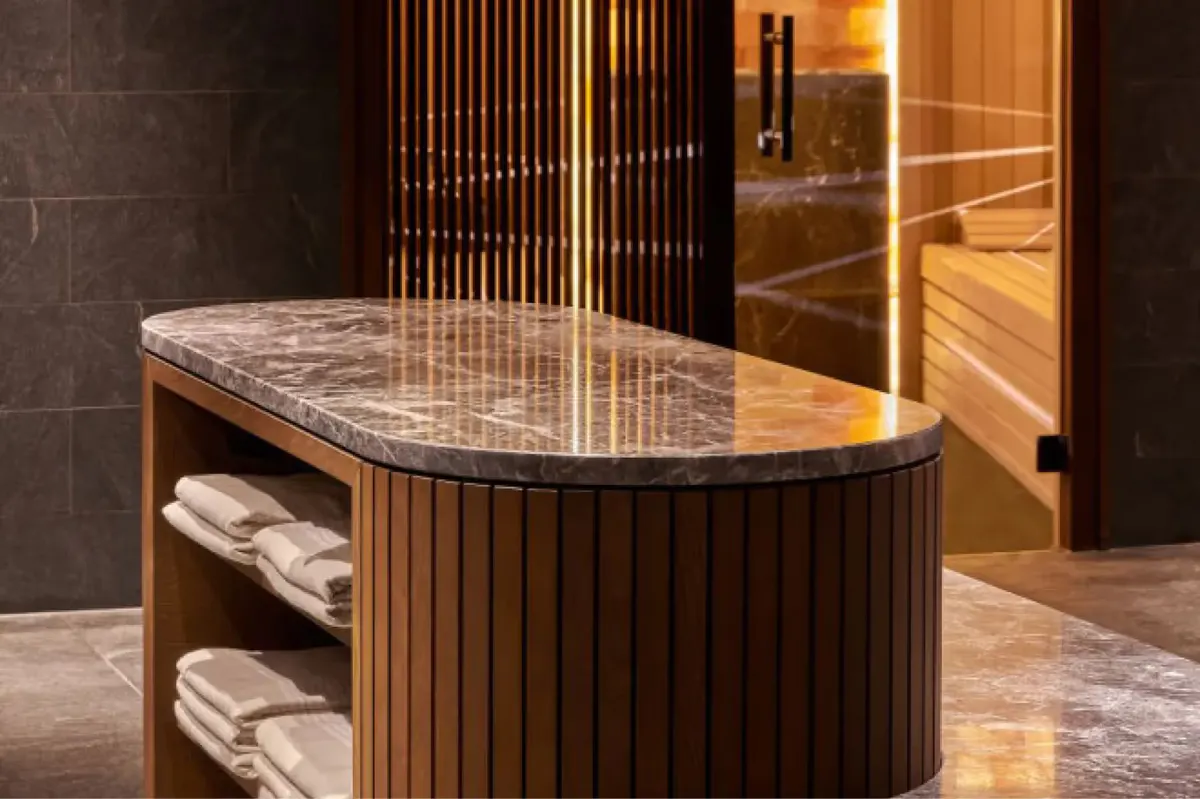 Spa treatment area with marble countertop, wood paneling, and ambient lighting