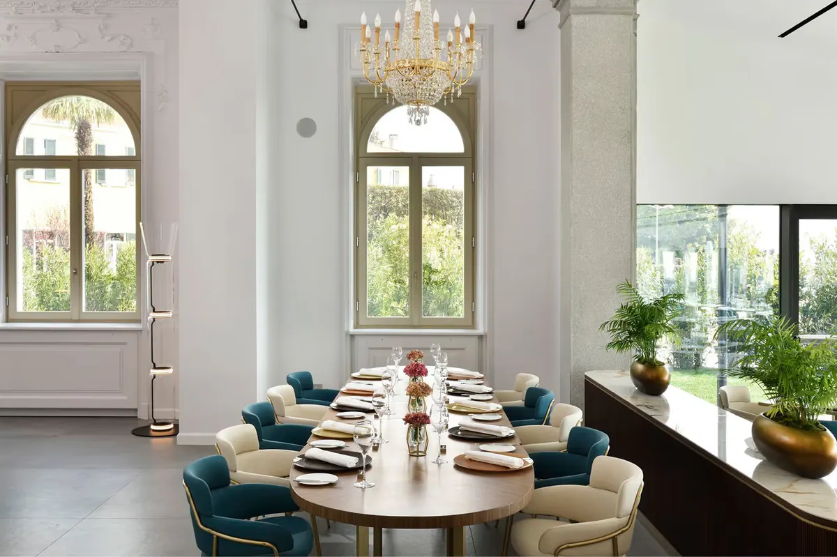 A wine cellar with tall glass doors and modern furnishings in white and cream