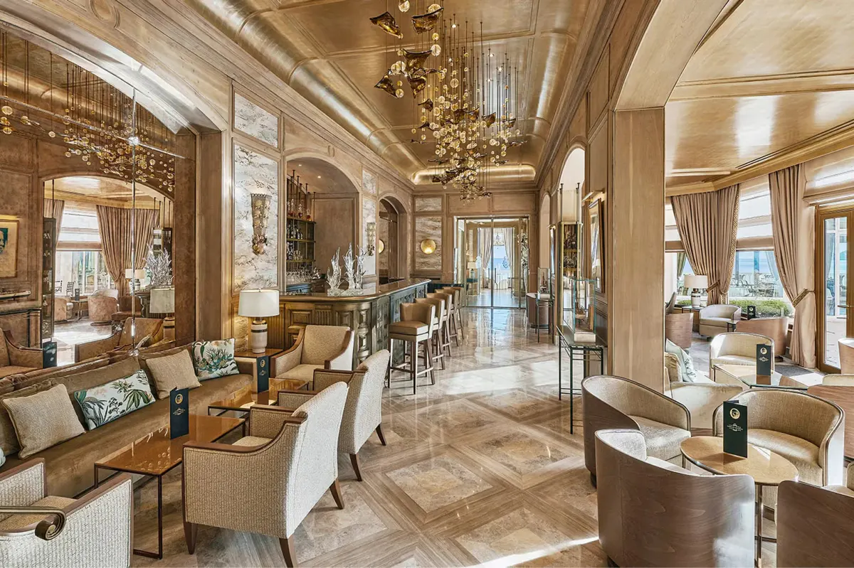 Spacious grand salon with connected dining areas and marble flooring