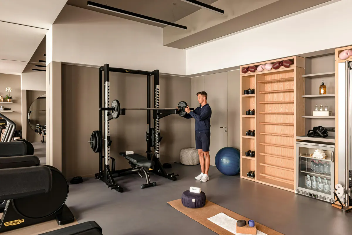 Fitness center with equipment and slotted wood accent wall