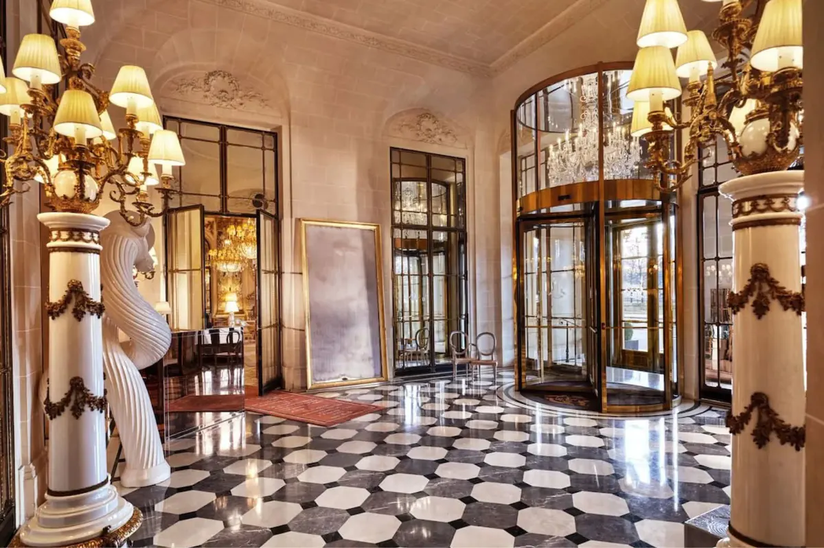The hotel’s ornate entrance hall with gilt architectural details and classical marble flooring