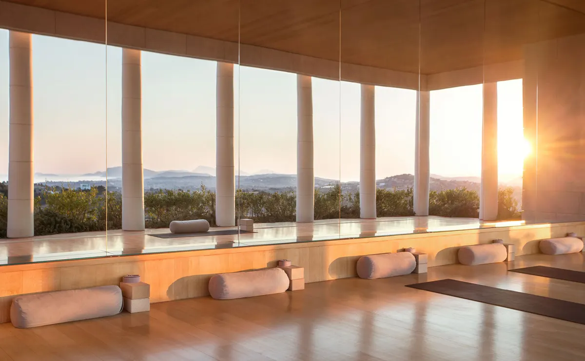 Spa yoga studio with columns and sea view at sunrise
