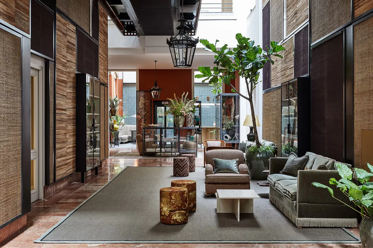 Hallway passage with potted plants and light-filled corridor