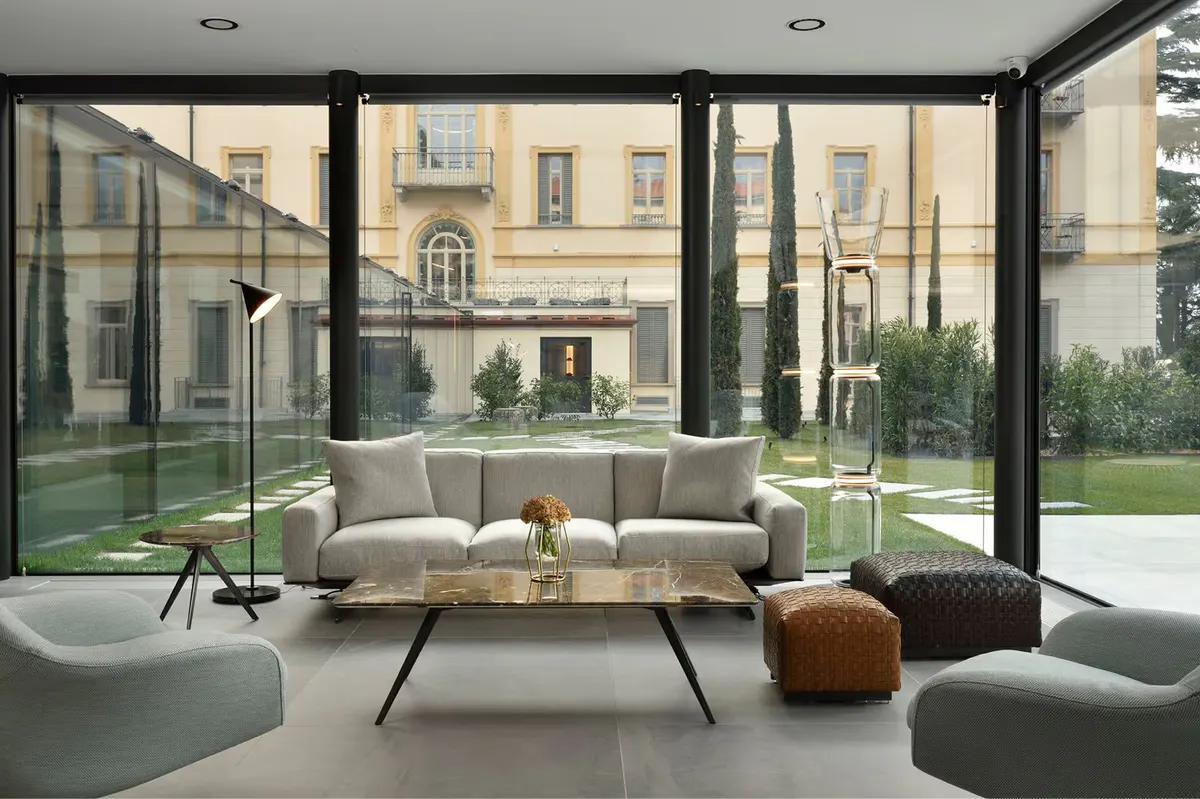 A modern lobby with glass walls, contemporary seating, and floor-to-ceiling views