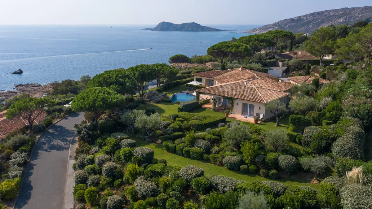 Coastal property with pool and private villas amid Mediterranean landscape