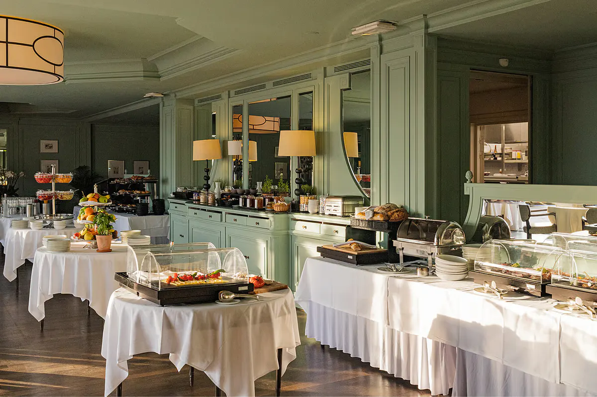Seafoam-green dining room with buffet service and table settings
