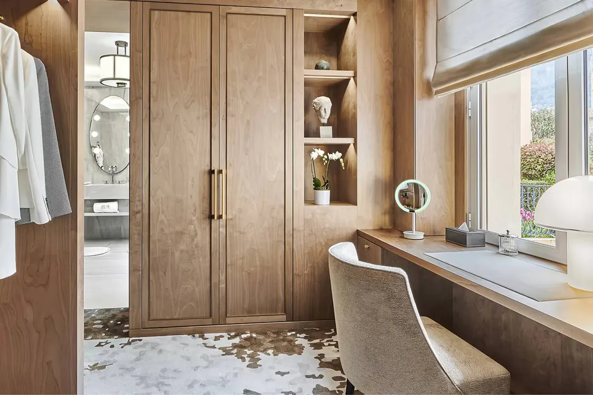 Dressing room with wood cabinetry and window seat overlooking the property