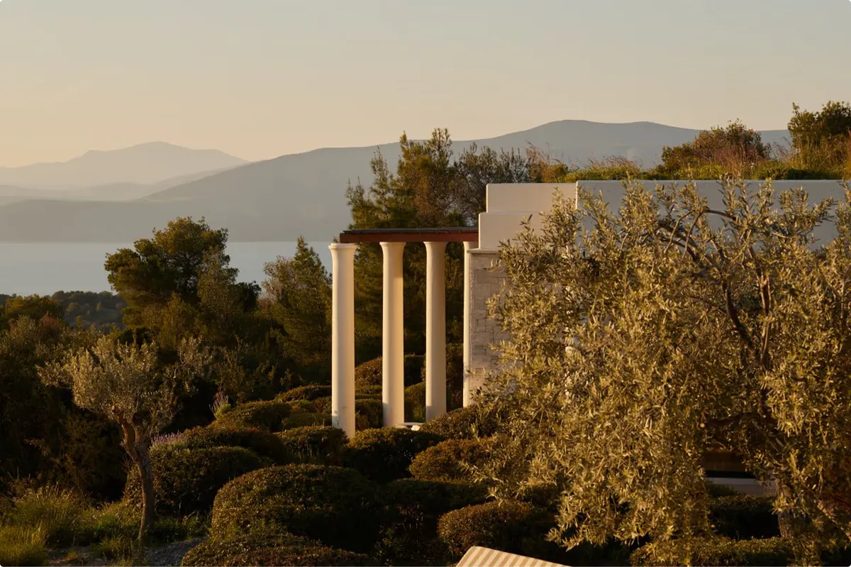 Classical columns silhouetted against the Aegean Sea at golden hour
