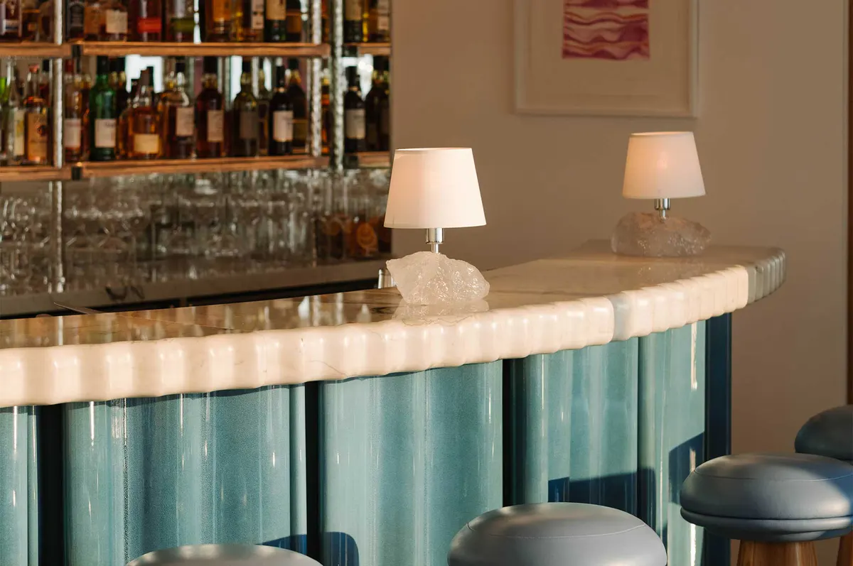 Bar counter with marble surface and bottle display