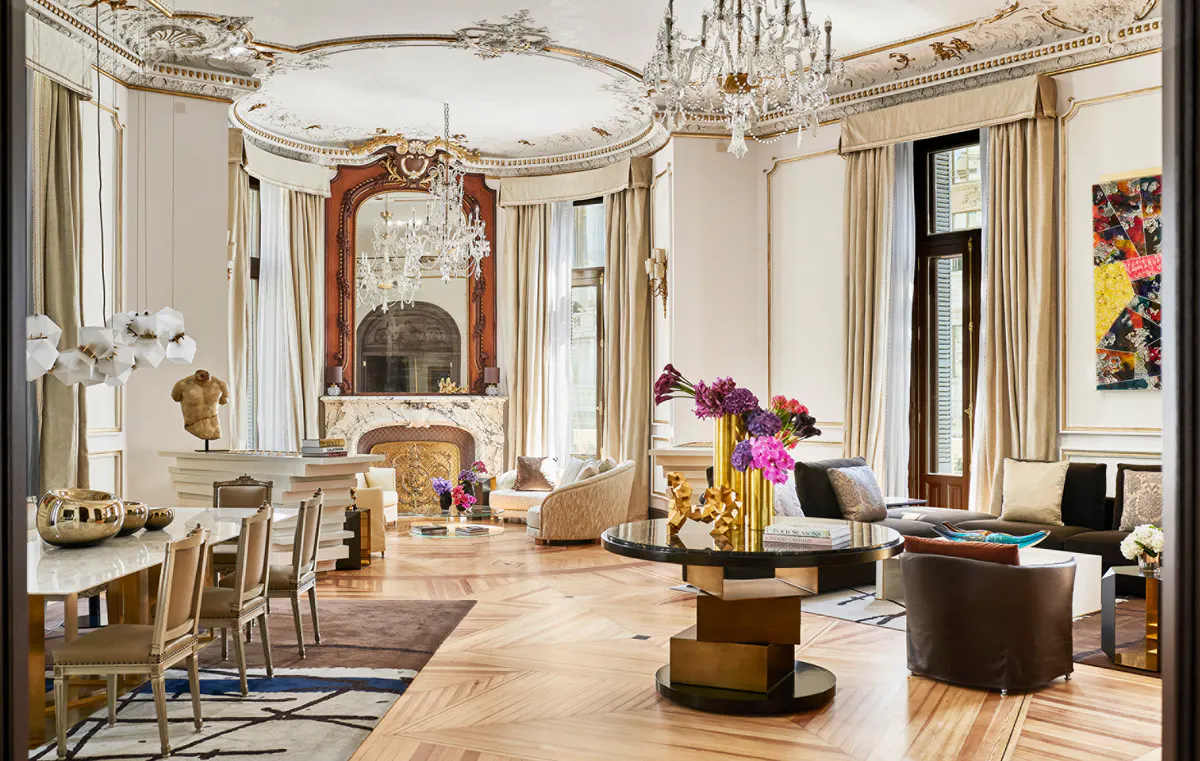 Penthouse suite with crystal chandeliers, frescoed ceiling, gilt mirrors, and gold-toned marble