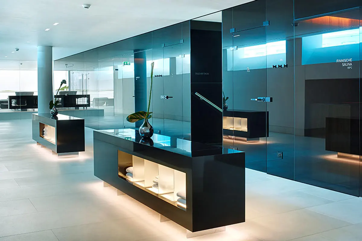 Spa reception area with turquoise blue lighting and glass dividers
