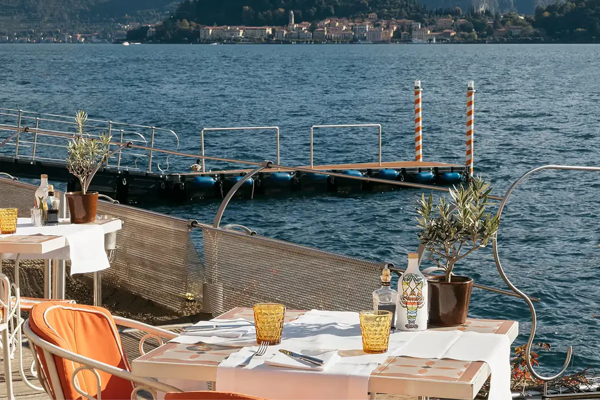 Outdoor table on lakeside platform with scenic water backdrop