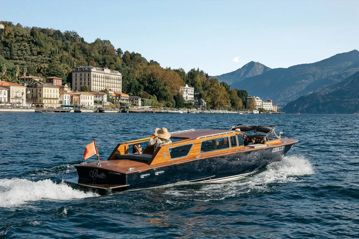 Wooden speedboat carrying passengers on Lake Como near the hotel