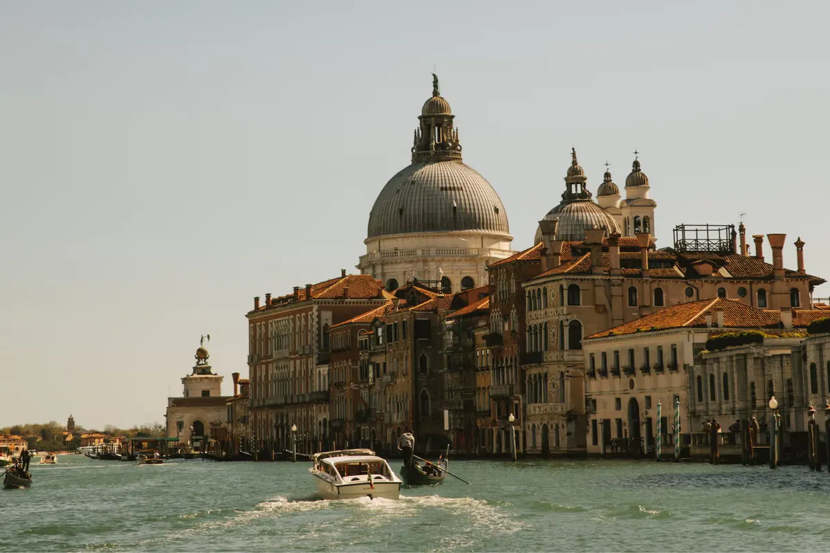 The Basilica di Santa Maria della Salute and Grand Canal buildings viewed from the water at dusk