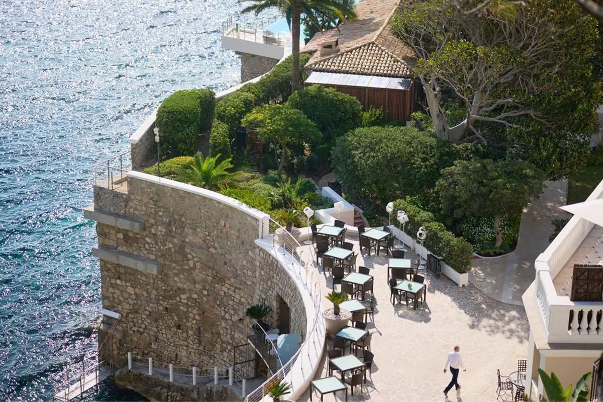 Terraced seating area carved into a stone cliff overlooking the sea