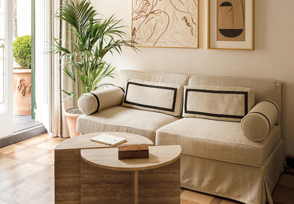 Sitting area with pale green sofa and botanical prints
