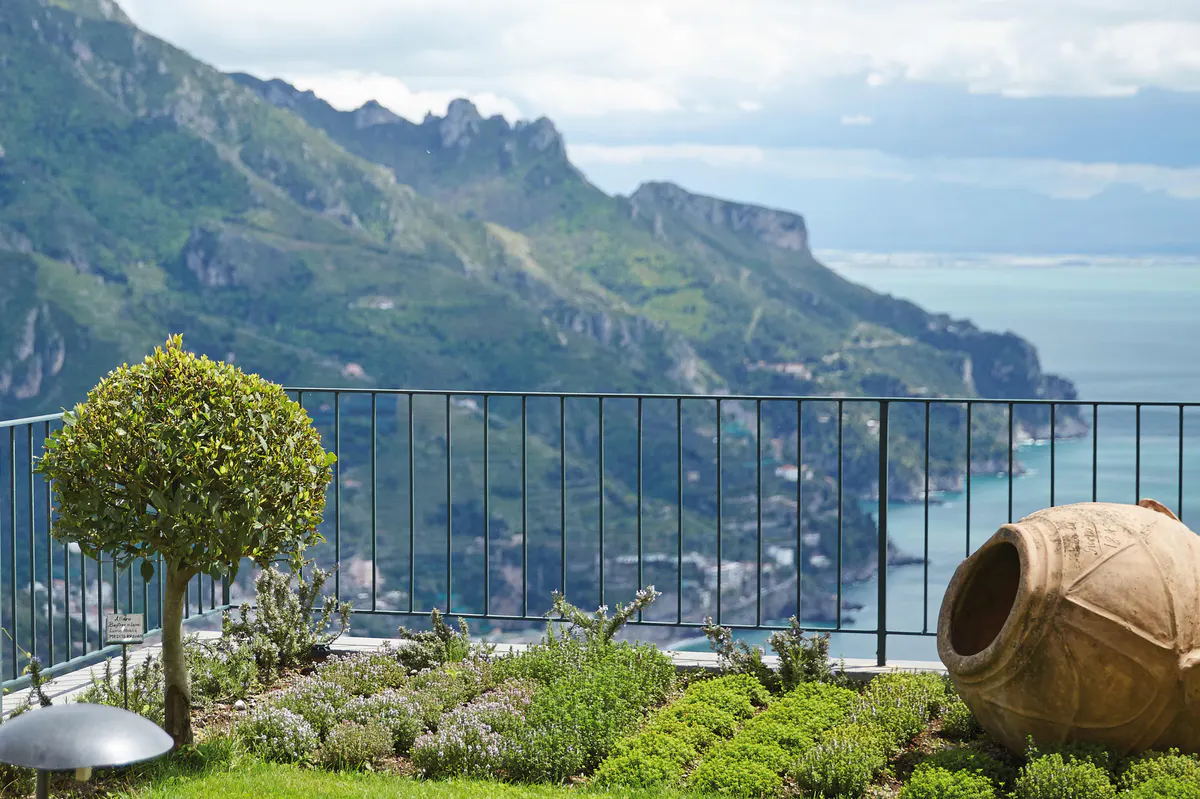 Terraced garden with sculptured planter overlooking forested hillsides and Mediterranean sea