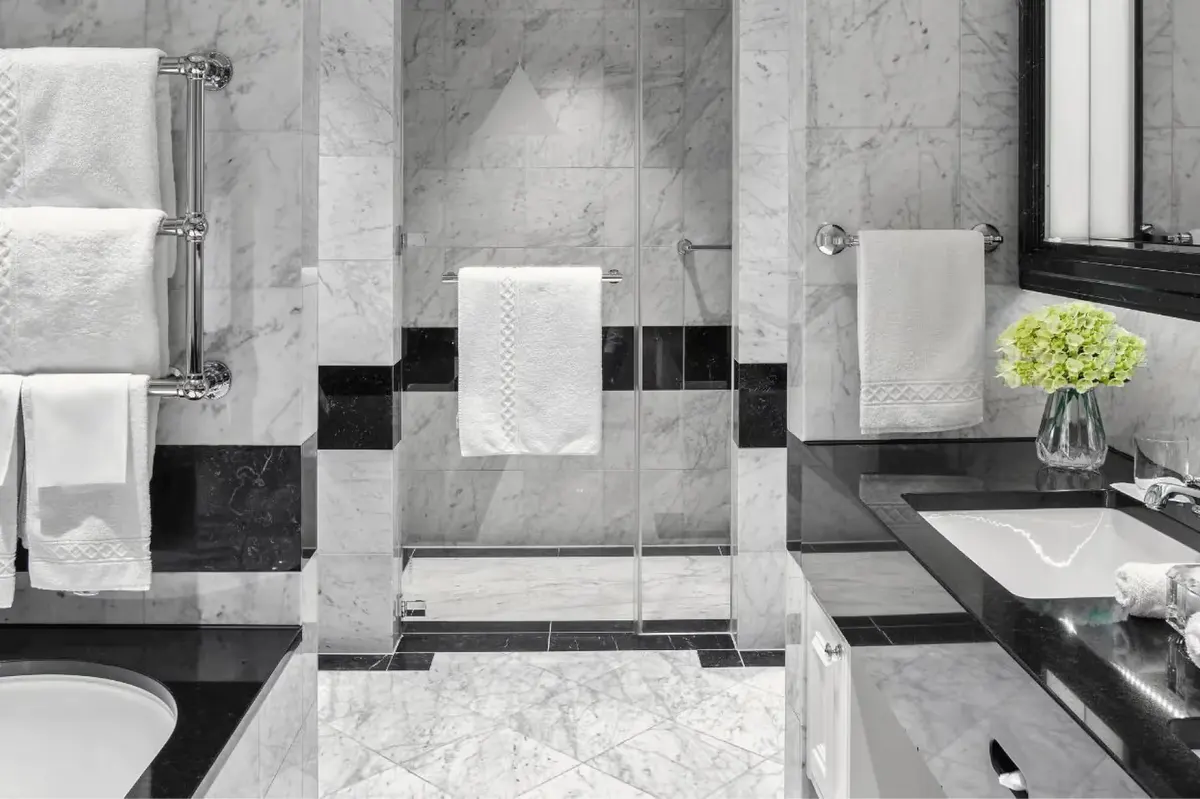Marble bathroom with black and white geometric tile pattern