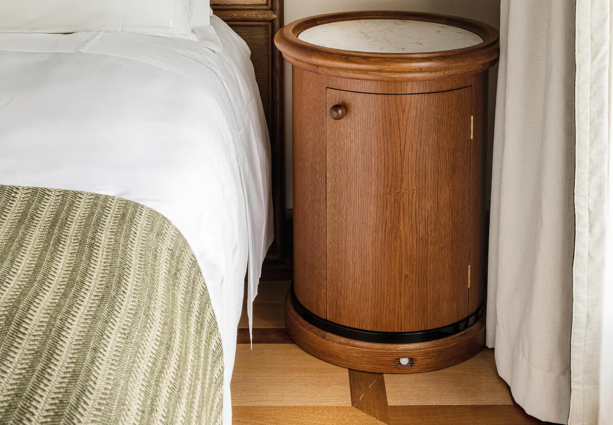 Wooden side table beside bed