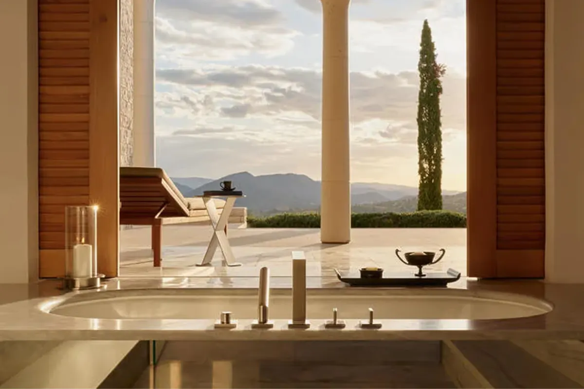 Modern stone villa exterior with cypress trees and sea horizon
