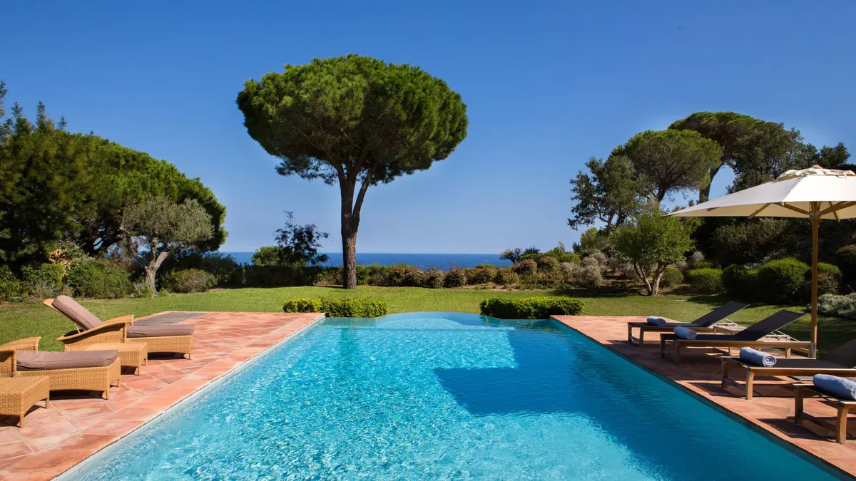 Rectangular pool with terracotta surround and blue Mediterranean view