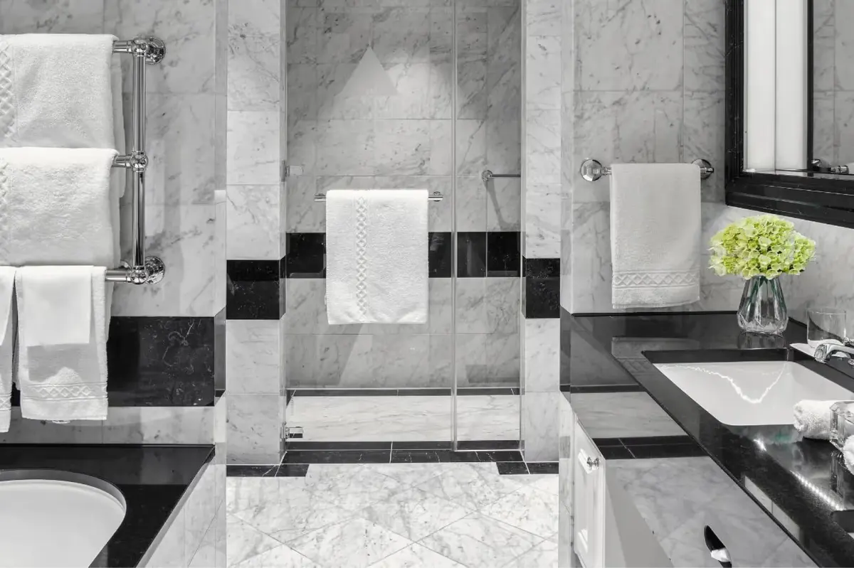 Marble bathroom with black and white geometric tile pattern