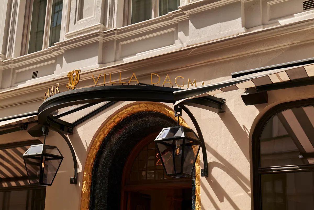 Cream-colored facade with ornate architectural details and street-level storefronts