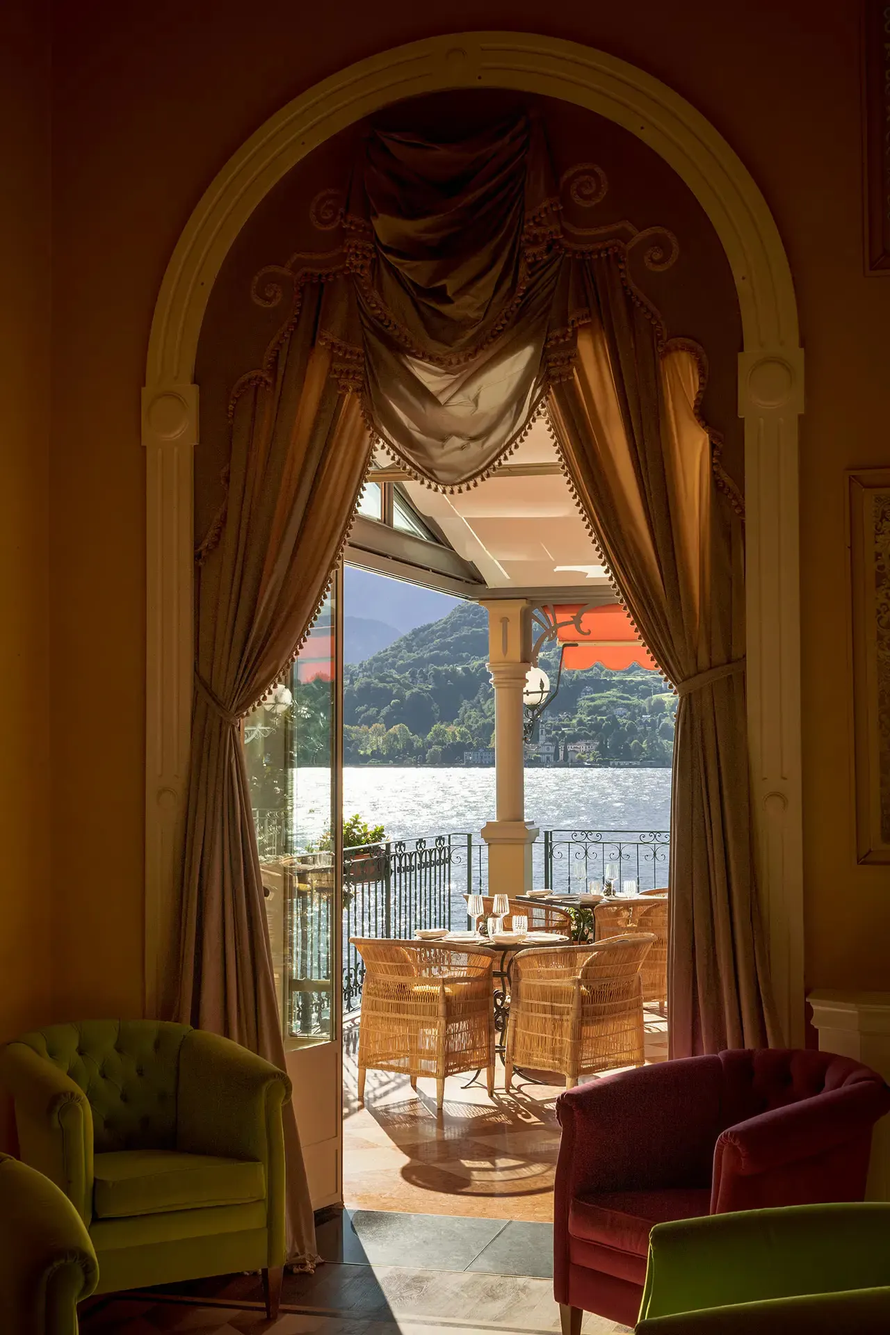 Gold curtains framing a balcony above Lake Como