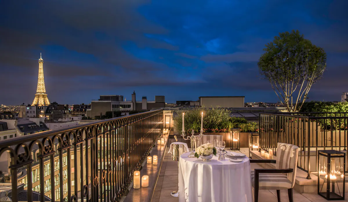 Indoor rooftop dining with floor-to-ceiling windows, city views, and elegant place settings