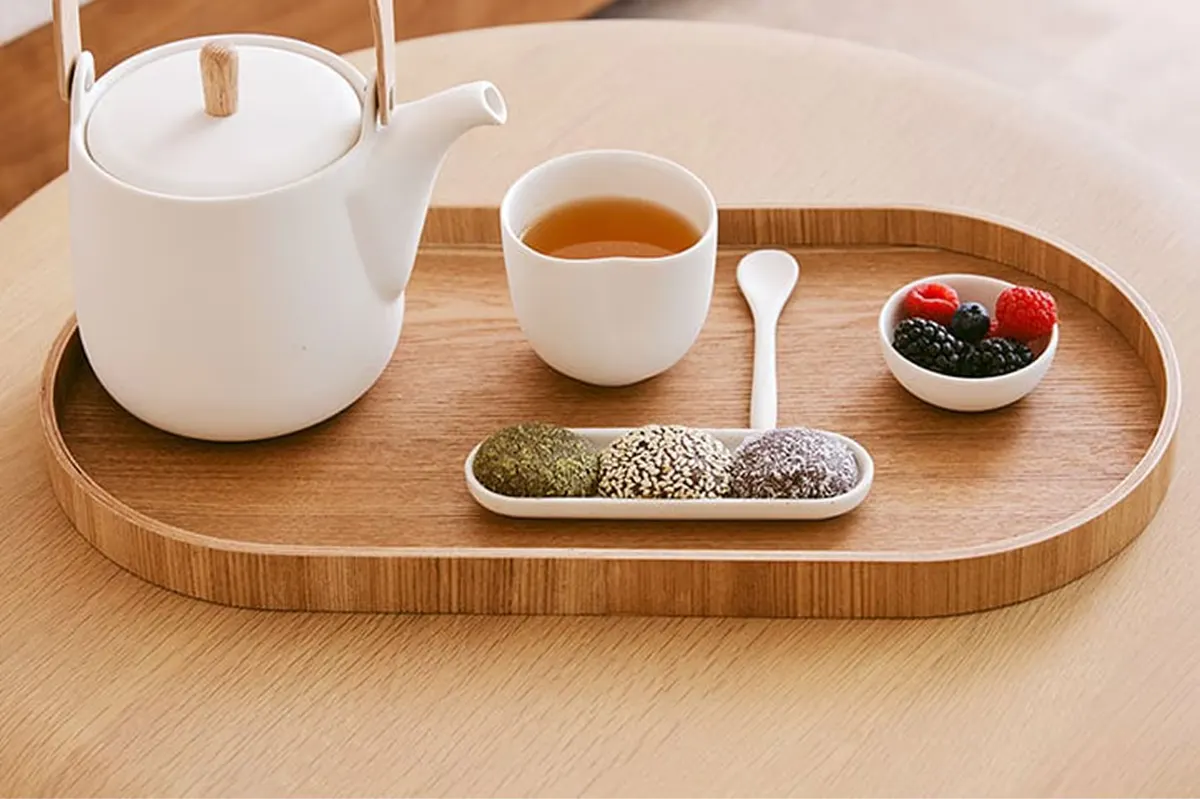Spa tea service on wooden tray with white teapot