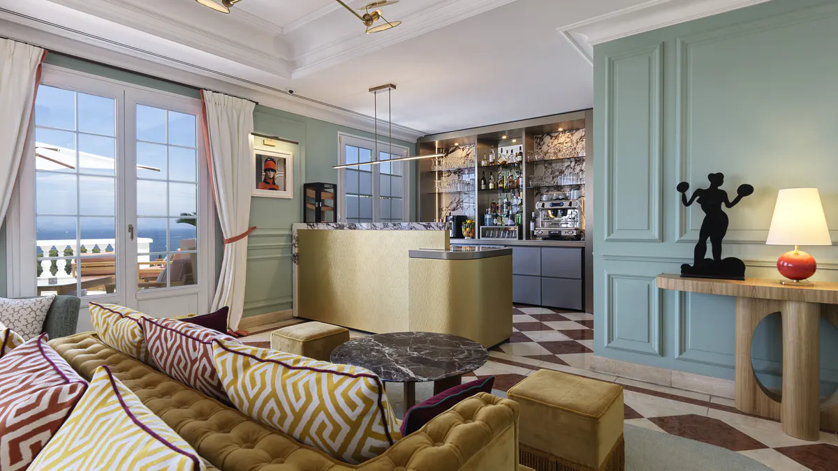 Seafoam-accented bar area with geometric flooring and open kitchen