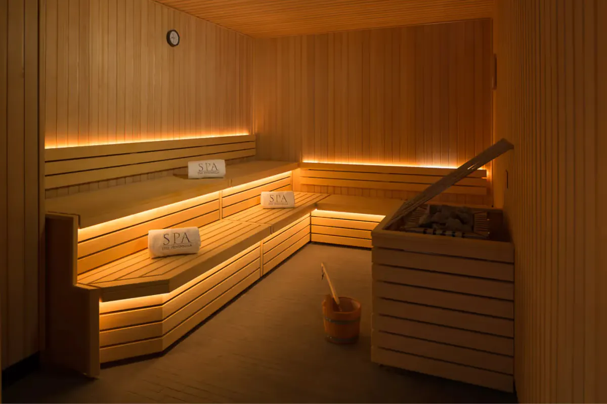 Sauna interior with horizontal cedar paneling and interior bench seating