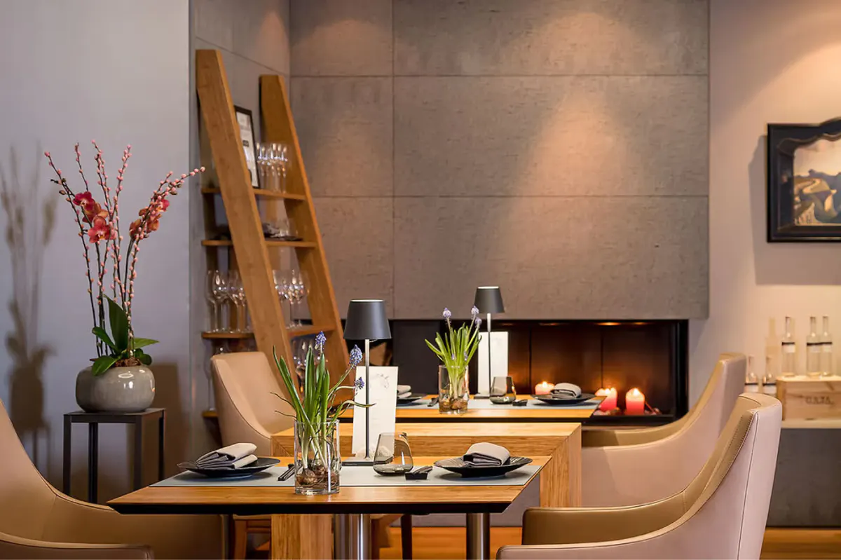 Intimate dining setting with fireplace and curved banquette seating