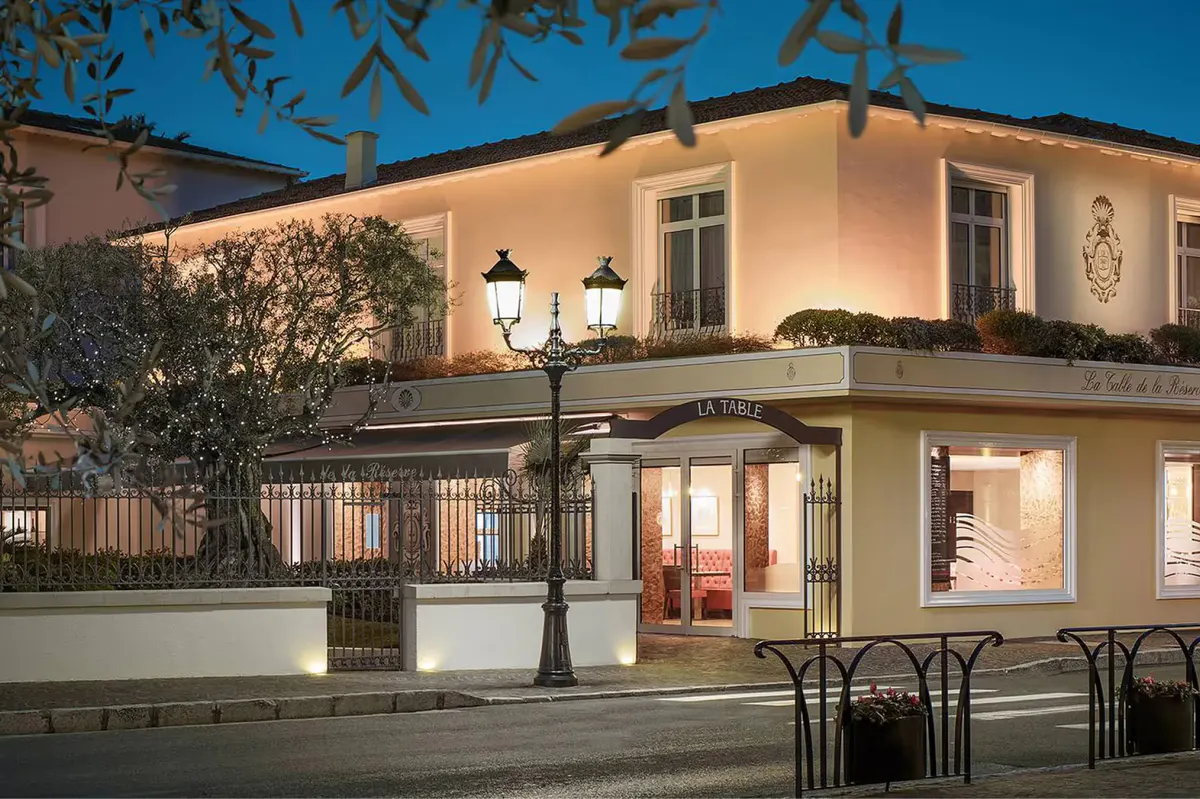 Elegant restaurant entrance lit at dusk with architectural details