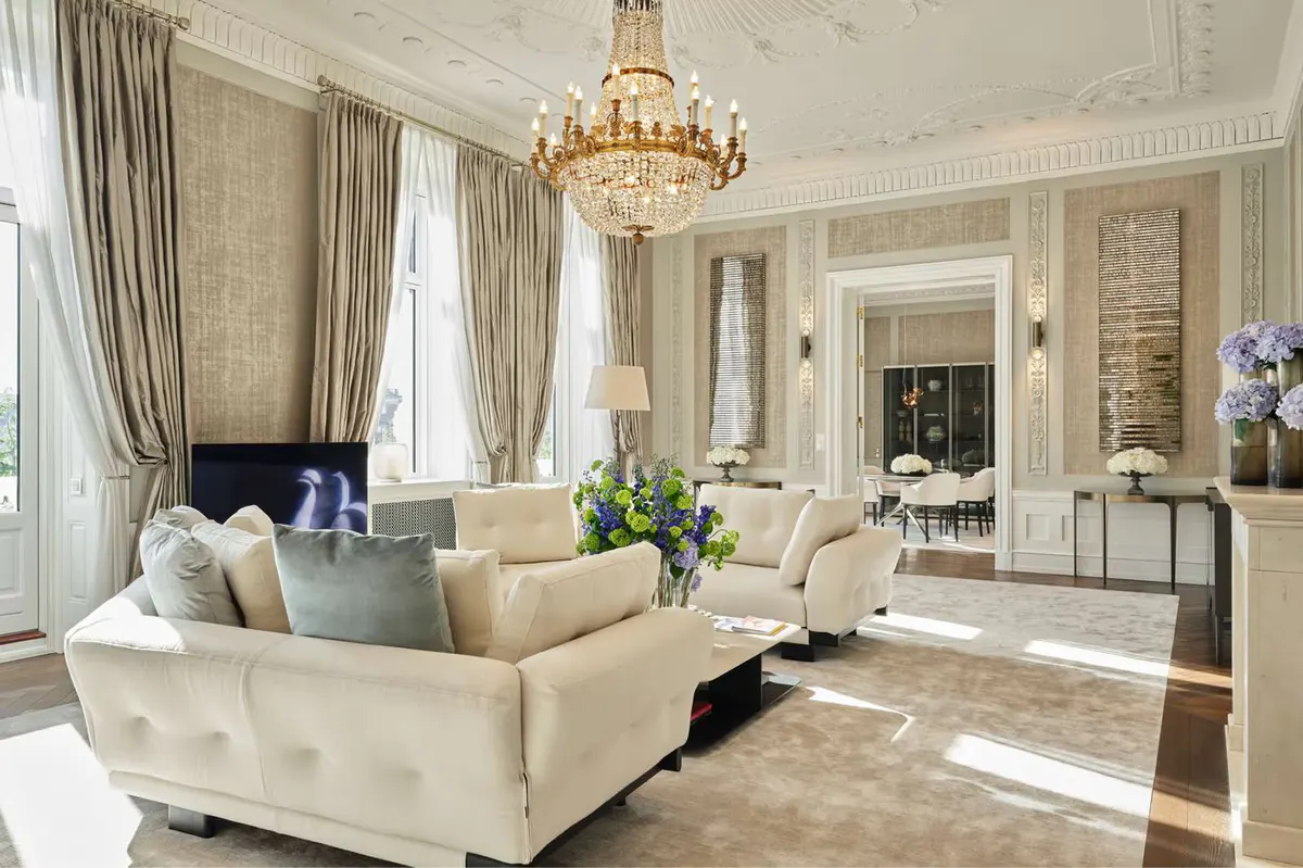 Suite with pale furniture, arched mirrors and soft natural light