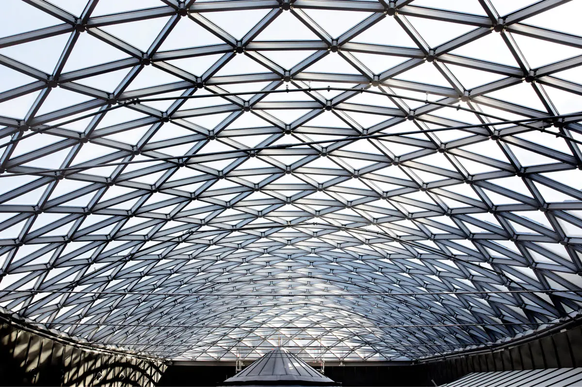 Geometric glass and steel roof structure with symmetrical lattice pattern