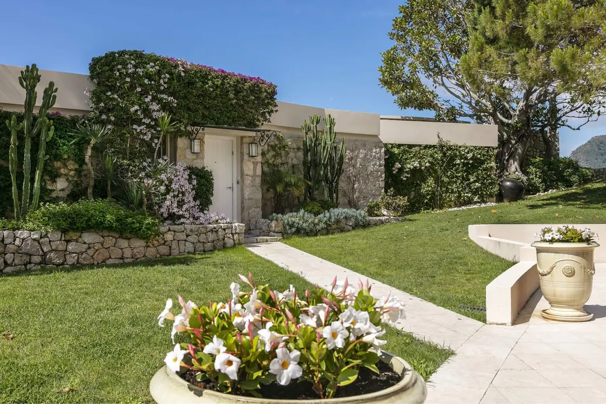 White stone pathways and colorful flower beds outside residential villas