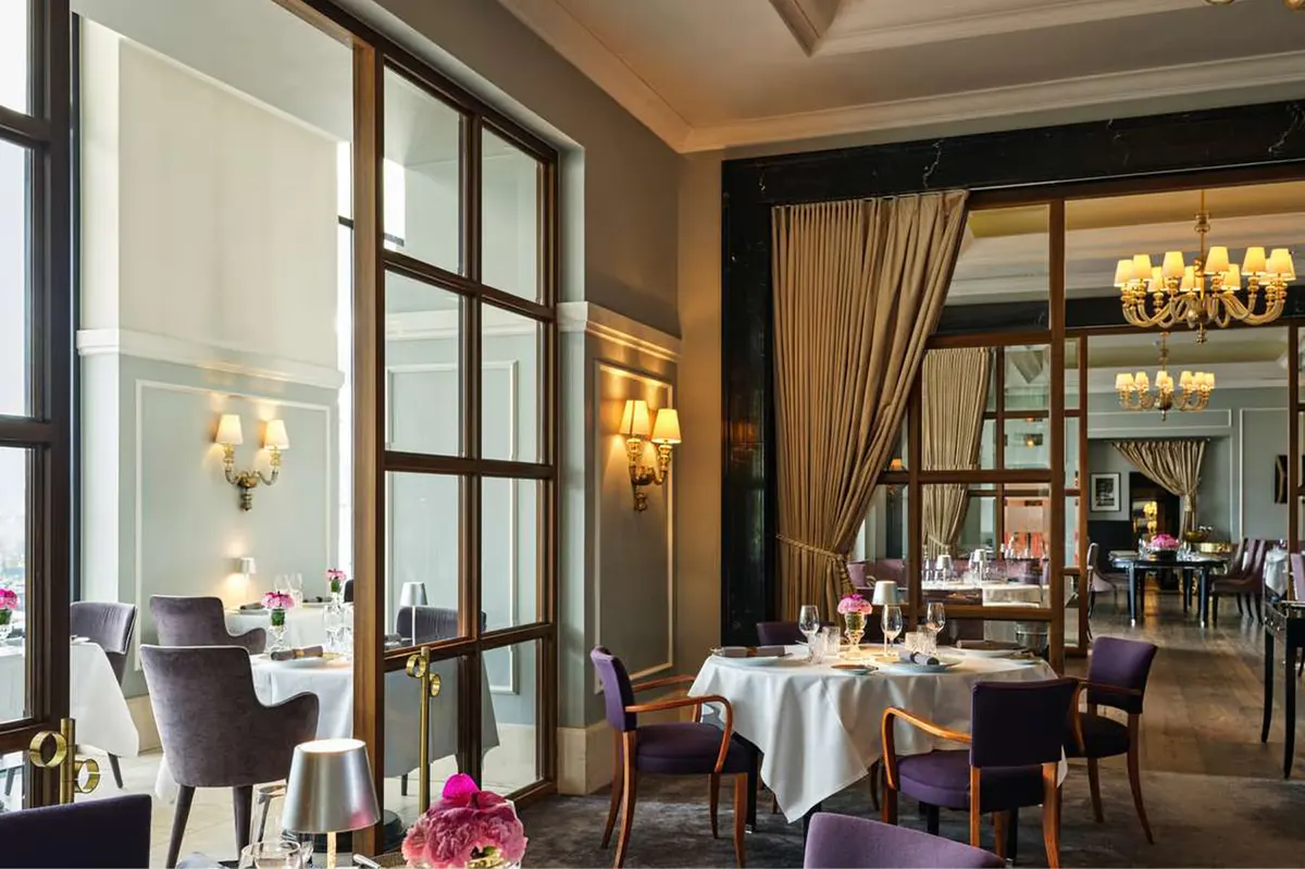 Dining room with brass fixtures, burgundy accents, and mirrored walls