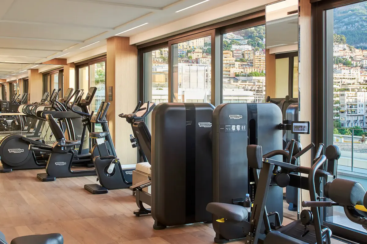 Fitness center with exercise equipment and floor-to-ceiling windows