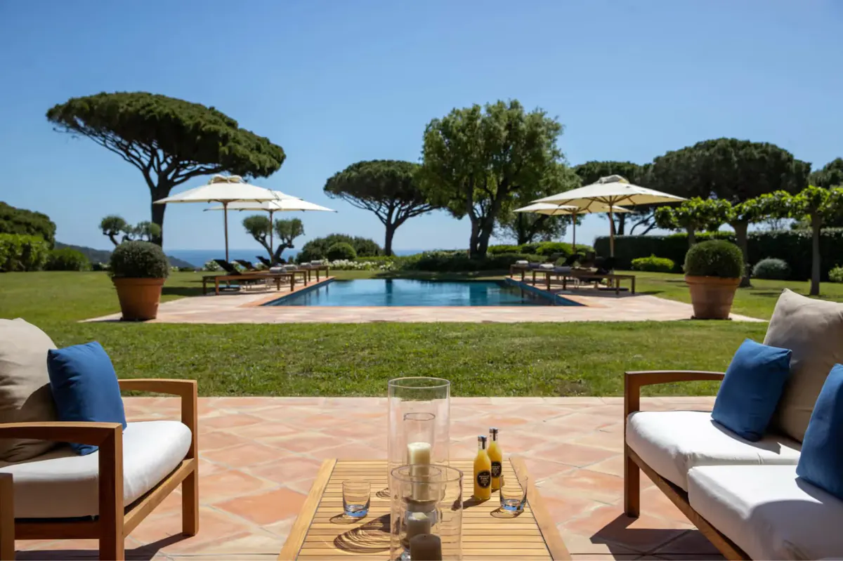 Pool terrace with Mediterranean pines and lounge seating area