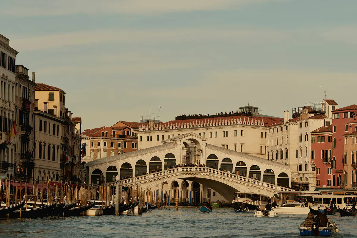 The Rialto Bridge spanning the Grand Canal with surrounding palaces and canal traffic