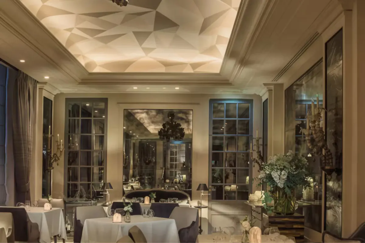 Bright gallery space with white linens, mirrors, and classical architectural details