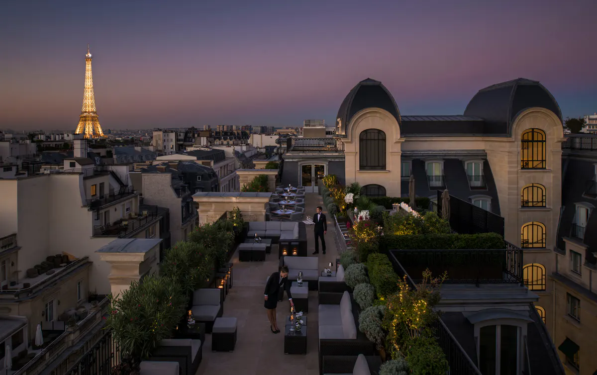 Building exterior at twilight with city views and the Eiffel Tower in the distance