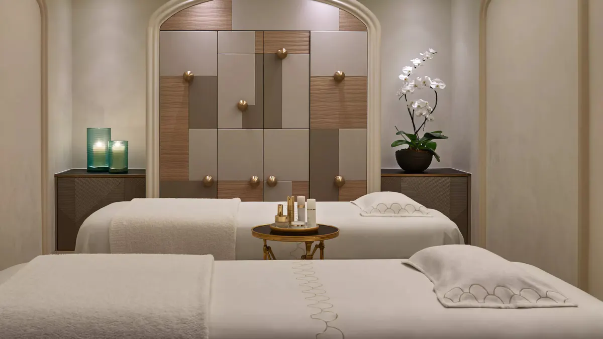Spa pool area with blue tiles, white loungers, and architectural detailing