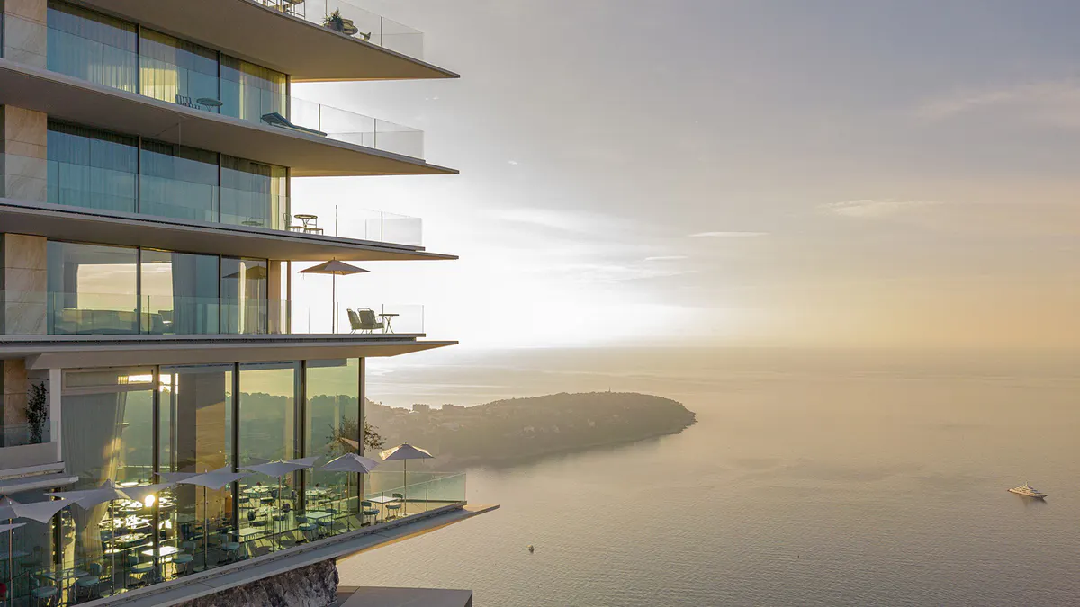 Glass-fronted suites overlooking Mediterranean at sunset